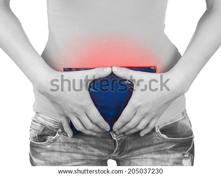 Acute pain in a woman stomach. Woman holding hand to spot of stomach.