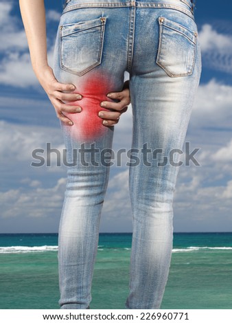Woman massaging her Hamstrings - Anatomy Muscles because it hurts.