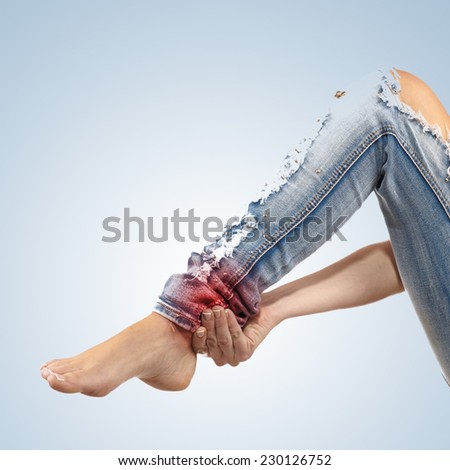 Pain in woman hamstring. Female holding hands on spot pain hamstring.