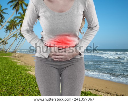 Woman with both palm around waistline to show pain and injury on belly area.