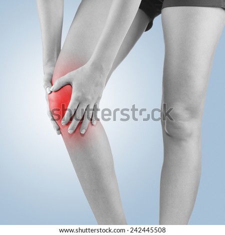 Pain in woman knee. Female holding hands on spot knee pain.