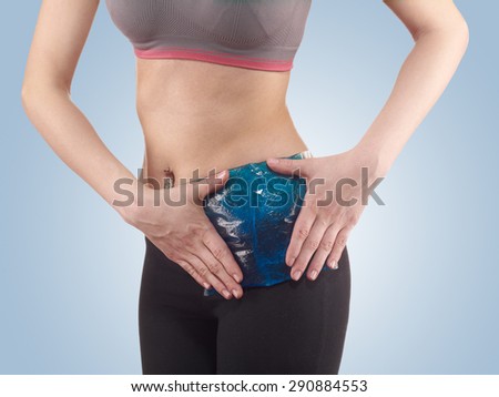 Woman\'s hands on stomach with Ice Packs for Pain Relief.  Pain medical concept.