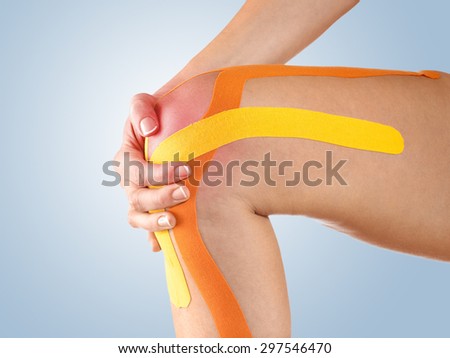 Sports injury - woman having pain in his knee making massage.