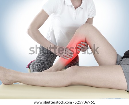 Doctor is stretching woman leg on physiotherapy session.