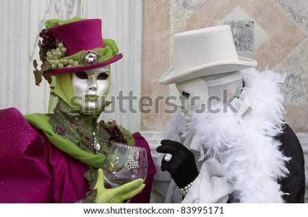 VENICE - MARCH 5: An unidentified couple in a Venetian costumes attend the Carnival of Venice, annual festival starting around two weeks before Ash Wednesday and ends on Shrove Tuesday, on March 5, 2011 in Venice, Italy.