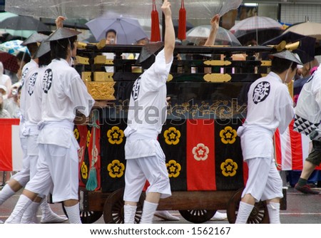 A procession in the rain at the Gion Festival in Kyoto, Japan.