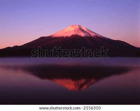 Reflections of Mount Fuji in a still early morning lake