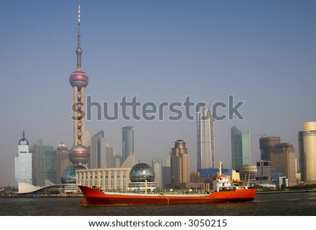 View of Shanghai with the Oriental Pearl Tower and a red ship in the foreground