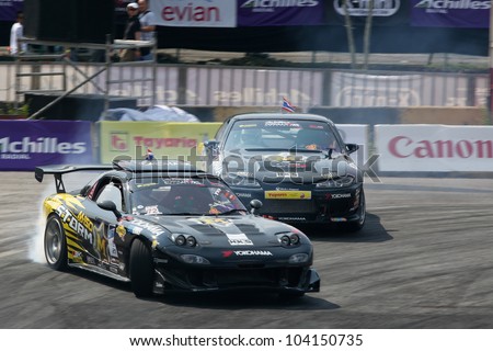 KUALA LUMPUR - MAY 20: Nattawoot (Oat) in a RX-7 car leads his team mate from the M150 Storm Team on a practice run at the Formula Drift 2012 Asia Round 1 on May 20, 2012 in Speedcity, Malaysia.