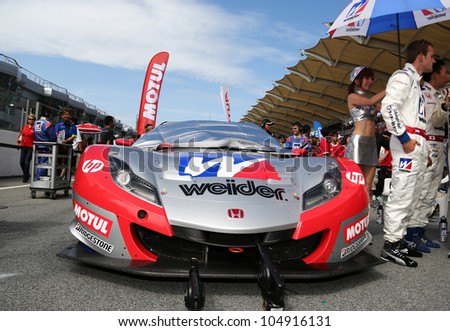 SEPANG - JUNE 10:The Honda HSV-010 car of Weider Honda Racing Team sits on the start grid the 2012 Autobacs SUPER GT Series Round 3 on June 10, 2012 at the Sepang International Circuit, Malaysia.