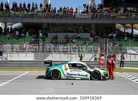 SEPANG - JUNE 10: The Racerbook Audi R8 LMS car of Hitotsuyama Racing waits on the start grid of the Autobacs SUPER GT Series Rd 3 on June 10, 2012 at the Sepang International Circuit, Malaysia.