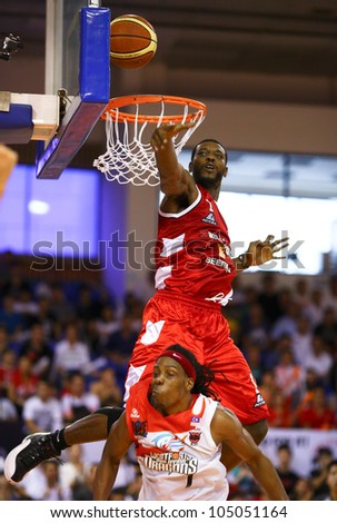 KUALA LUMPUR - JUNE 02: Vincent Crews (Beermen) jumps above Tiras Wade (Dragons) to block his lay up shot in a playoff match in the ASEAN Basketball League on June 02, 2012 in Kuala Lumpur, Malaysia.