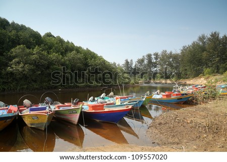 KUANTAN, MALAYSIA - AUG 03: Fishermen boats line up moored on the river bank on August 03, 2012 in Kuantan, Malaysia.  Fishery had been traditionally an important industry in this coastal town.