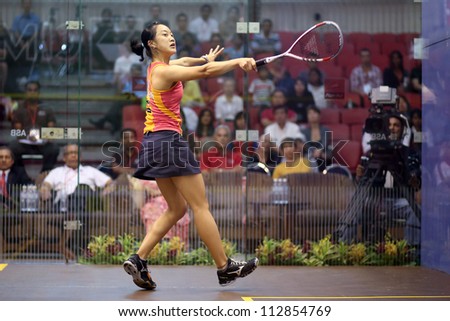 DAMANSARA - SEP 14: Low Wee Wern (orange) volleys a return shot in the women\'s semi-final of the CIMB Malaysian Open Squash Championships 2012 held in Damansara, Malaysia on September 14, 2012.
