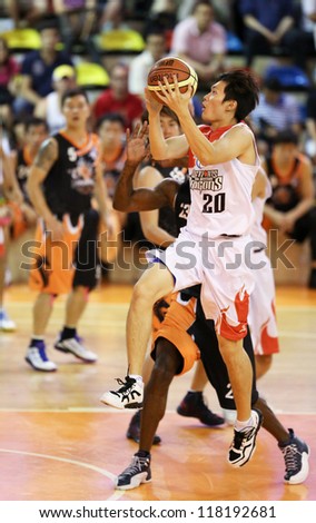 KUALA LUMPUR - OCTOBER 28: Dragons\' Loh Shee Fai  #20 scores an easy basket against the Firehorse team in a Malaysia National Basketball League match on October 28, 2012 in Kuala Lumpur, Malaysia.