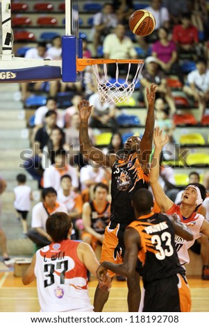 KUALA LUMPUR - OCT 28: Firehorse\'s players (black) and Dragon\'s players (white) scramble for a loose ball in a Malaysia National Basketball League match on October 28, 2012 in Kuala Lumpur, Malaysia.