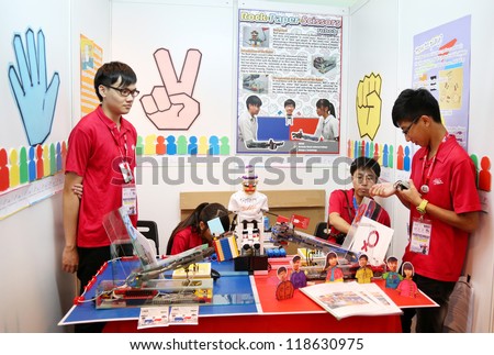 SUBANG JAYA - NOV 10: Unidentified students from Hong Kong build a robot that allow people to play a hand game by remote at the World Robot Olympaid on November 10, 2012 in Subang Jaya, Malaysia.