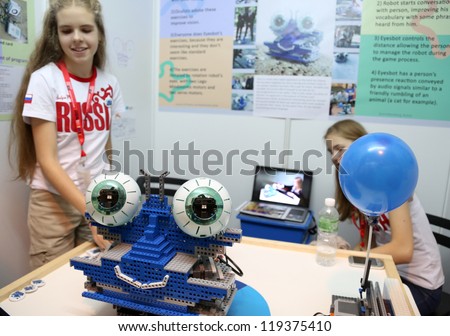 SUBANG JAYA - NOVEMBER 10: Unidentified Russian students shows a robot to people to exercise their eyes to improve vision at the World Robot Olympaid on November 10, 2012 in Subang Jaya, Malaysia.