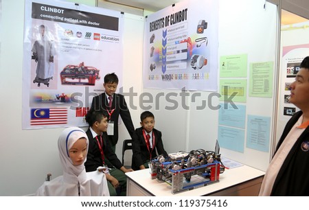 SUBANG JAYA - NOV 10: Unidentified Malaysian students shows their robot nurse who can communicate and check patient\'s vital signs at the World Robot Olympaid on Nov 10, 2012 in Subang Jaya, Malaysia.