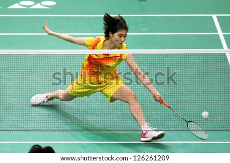 KUALA LUMPUR - JANUARY 15: China\'s Xuan Deng retrieves the shuttlecock during her qualifying match at the Maybank Malaysia Open 2013 Badminton event on January 15, 2013 in Kuala Lumpur, Malaysia.