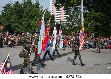 KUALA LUMPUR - AUGUST 31: Women flag-bearers representing the Malaysian Armed Forces march on the city streets celebrating Malaysia\'s Independence Day on August 31, 2013 in Kuala Lumpur, Malaysia.