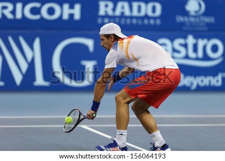KUALA LUMPUR - SEPTEMBER 28: Jurgen Melzer volleys a return to Joao Sousa in a semi-final match of the Malaysia Open 2013 tennis played at the Putra Stadium, Malaysia on September 28, 2013.