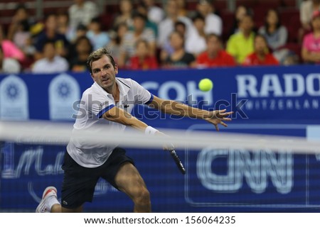 KUALA LUMPUR - SEPTEMBER 28: Julien Benneteau volleys a return to Stanilas Wawrinka in a semi-final match of the Malaysia Open 2013 tennis played at the Putra Stadium, Malaysia on September 28, 2013.