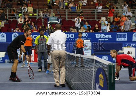 KUALA LUMPUR - SEPTEMBER 27: Stan Wawrinka and Dimitry Tursunov views the coin toss at a quarter-final match of the Malaysia Open 2013 tennis at the Putra Stadium, Malaysia on September 27, 2013.