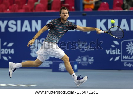KUALA LUMPUR - SEPTEMBER 27: Adrian Mannarino volleys a return to Julien Benneteau in a semi-final match of the Malaysia Open 2013 tennis played at the Putra Stadium, Malaysia on September 27, 2013.