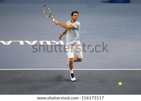 KUALA LUMPUR - SEPTEMBER 25: Adrian Mannarino (France) hits a forehand return in a first round tennis match at the Malaysia Open 2013 played at the Putra Stadium, Malaysia on September 25, 2013.