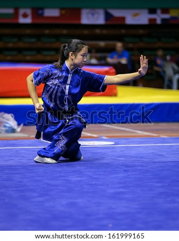KUALA LUMPUR - NOV 03: Emily Huang of the USA shows her fighting style in the \'changquan compulsory\' event at the 12th World Wushu Championship on November 03, 2013 in Kuala Lumpur, Malaysia.