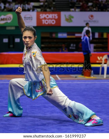 KUALA LUMPUR - NOV 03: Phoon Eyin of Malaysia shows her fighting style in the \'changquan compulsory\' event at the 12th World Wushu Championship on November 03, 2013 in Kuala Lumpur, Malaysia.