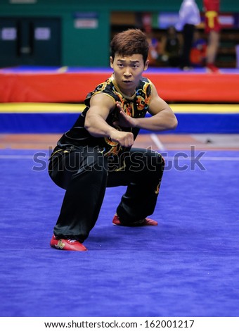 KUALA LUMPUR - NOV 03: Lee Yongmun of South Korea shows his fighting style in the \'nan quan compulsory\' event at the 12th World Wushu Championship on November 03, 2013 in Kuala Lumpur, Malaysia.