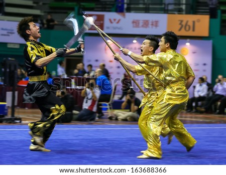 KUALA LUMPUR - NOV 05: Hong Kong\'s dalian team performs a fight scene in the Men\'s Dual Event at the 12th World Wushu Championship on November 05, 2013 in Kuala Lumpur, Malaysia.