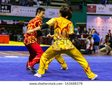 KUALA LUMPUR - NOV 05: South Korea\'s dalian team performs a fight scene in the Men\'s Dual Event at the 12th World Wushu Championship on November 05, 2013 in Kuala Lumpur, Malaysia.