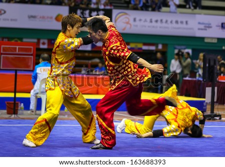 KUALA LUMPUR - NOV 05: South Korea's dalian team performs a fight scene in the Men's Dual Event at the 12th World Wushu Championship on November 05, 2013 in Kuala Lumpur, Malaysia.