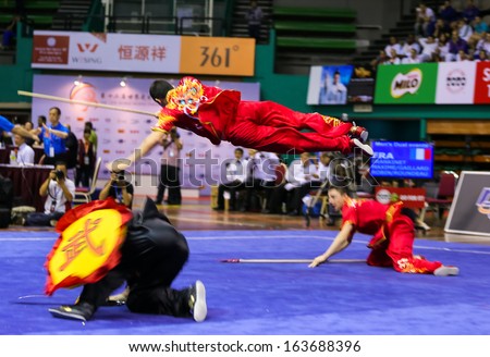 KUALA LUMPUR - NOV 05: France\'s dalian team performs a fight scene in the Men\'s Dual Event at the 12th World Wushu Championship on November 05, 2013 in Kuala Lumpur, Malaysia.