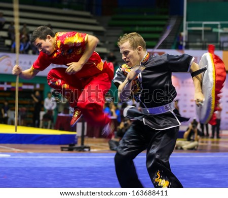 KUALA LUMPUR - NOV 05: France's dalian team performs a fight scene in the Men's Dual Event at the 12th World Wushu Championship on November 05, 2013 in Kuala Lumpur, Malaysia.