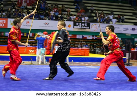 KUALA LUMPUR - NOV 05: France\'s dalian team performs a fight scene in the Men\'s Dual Event at the 12th World Wushu Championship on November 05, 2013 in Kuala Lumpur, Malaysia.