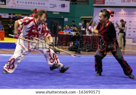 KUALA LUMPUR - NOV 05: Members of the Hong Kong dalian team performs a fight scene in the Women\'s Dual Event at the 12th World Wushu Championship on November 05, 2013 in Kuala Lumpur, Malaysia.