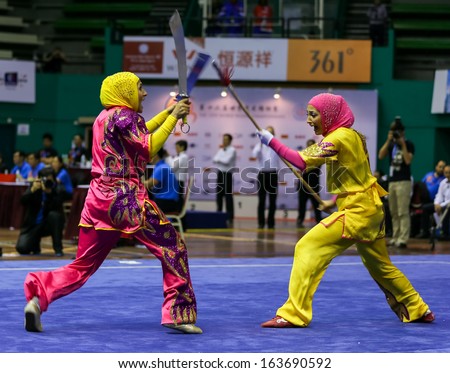 KUALA LUMPUR - NOV 05: Members of the Iranian dalian team performs a fight scene in the Women's Dual Event at the 12th World Wushu Championship on November 05, 2013 in Kuala Lumpur, Malaysia.