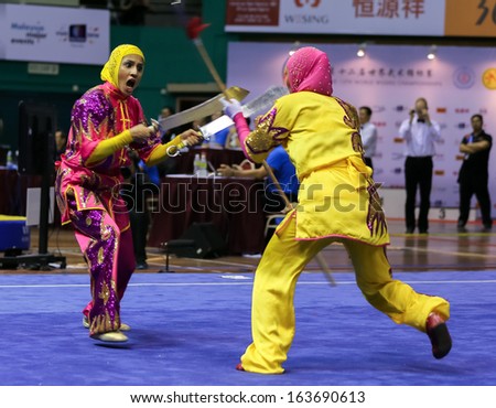 KUALA LUMPUR - NOV 05: Members of the Iranian dalian team performs a fight scene in the Women's Dual Event at the 12th World Wushu Championship on November 05, 2013 in Kuala Lumpur, Malaysia.
