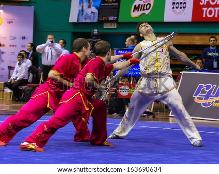 KUALA LUMPUR - NOV 05: Members of Ukraine's dalian team performs a fight scene in the Men's Dual Event at the 12th World Wushu Championship on November 05, 2013 in Kuala Lumpur, Malaysia.