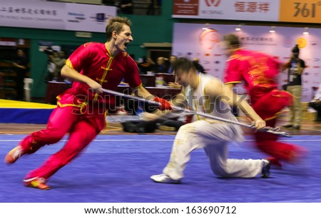 KUALA LUMPUR - NOV 05: Members of Ukraine\'s dalian team performs a fight scene in the Men\'s Dual Event at the 12th World Wushu Championship on November 05, 2013 in Kuala Lumpur, Malaysia.