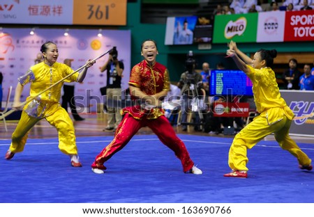 KUALA LUMPUR - NOV 05: Members of Macau\'s dalian team performs a fight scene in the Women\'s Dual Event at the 12th World Wushu Championship on November 05, 2013 in Kuala Lumpur, Malaysia.