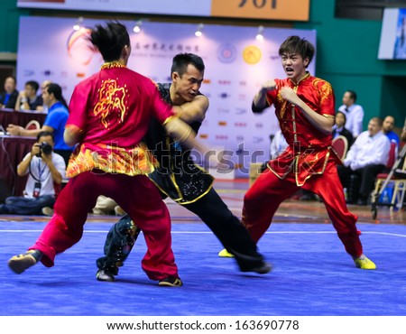 KUALA LUMPUR - NOV 05: Members of Malaysia\'s dalian team performs a fight scene in the Men\'s Dual Event at the 12th World Wushu Championship on November 05, 2013 in Kuala Lumpur, Malaysia.