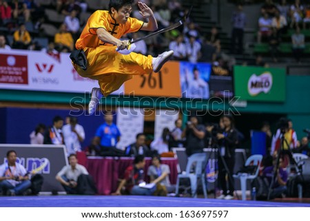 KUALA LUMPUR - NOV 03: Brazil\'s Henry Yuji Nakata executes a high kick in the Men\'s \'Daoshu\' Event at the 12th World Wushu Championship on November 03, 2013 in Kuala Lumpur, Malaysia.
