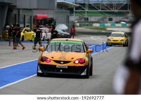 SEPANG, MALAYSIA - MAY 10, 2014: The race cars return to the pit lane after the free practice session of the Malaysian Super Series Round 2 in Sepang International Circuit.