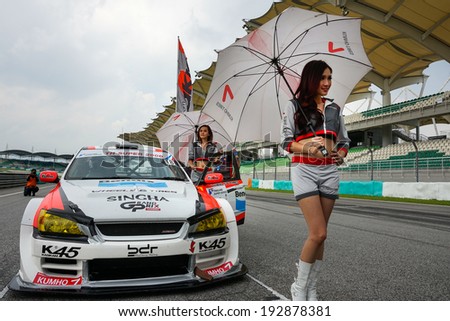 SEPANG, MALAYSIA - MAY 11, 2014: The Singha XO Team Eakie grid girls pose with the team car, a Toyota Altezza, at the start grid of the Thailand Super 2000 Race at the Sepang International Circuit.