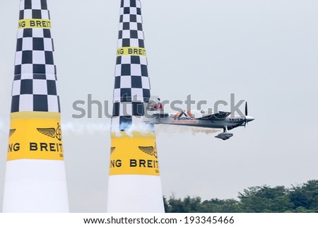 PUTRAJAYA, MALAYSIA - MAY 17, 2014: World champion Hannes Arch from Austria, in an Edge 540 V3 plane flies past the pylons at the qualifying session of the Red Bull Air Race World Championship 2014.
